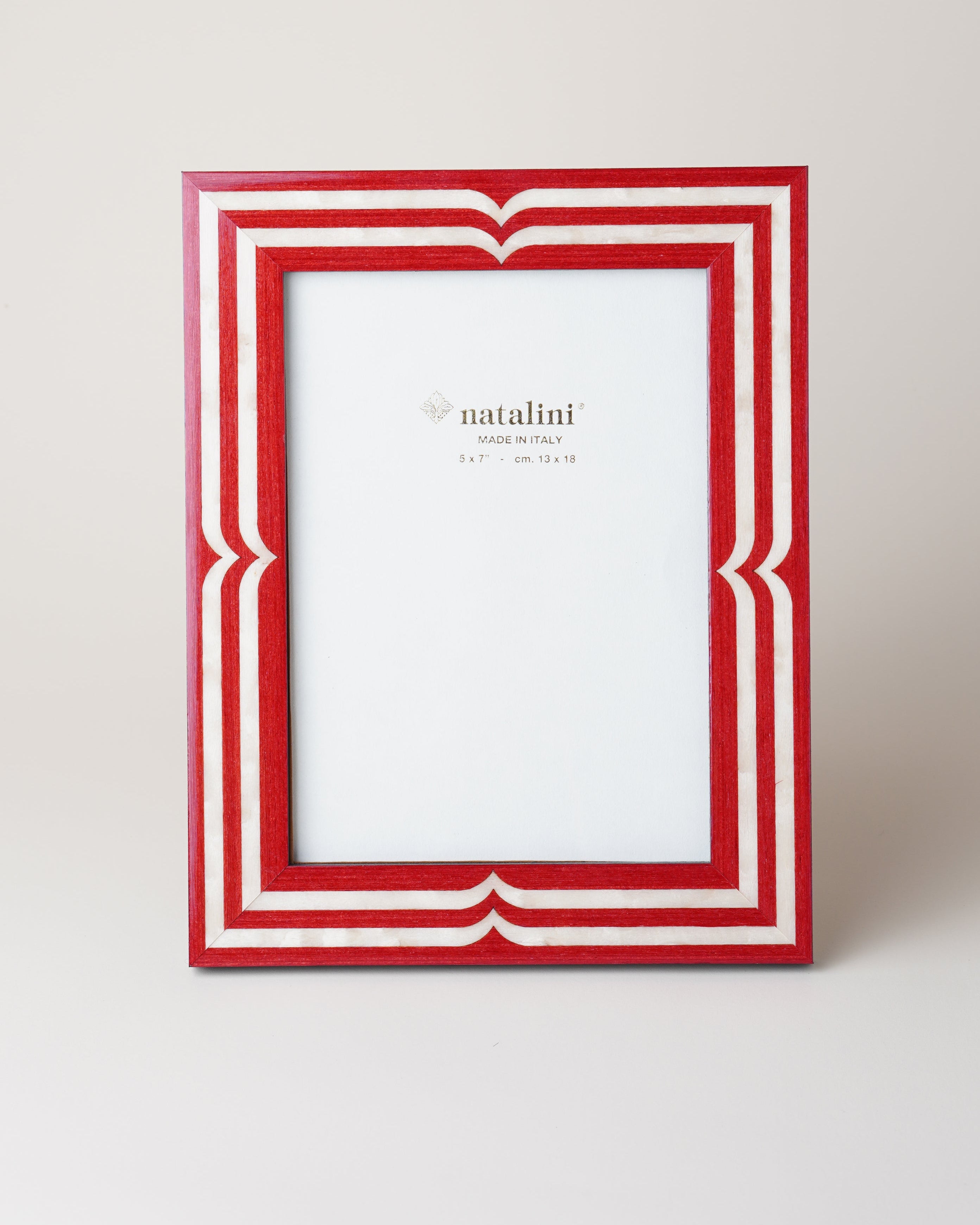 A red and white picture frame with a decorative border, standing against a plain background.