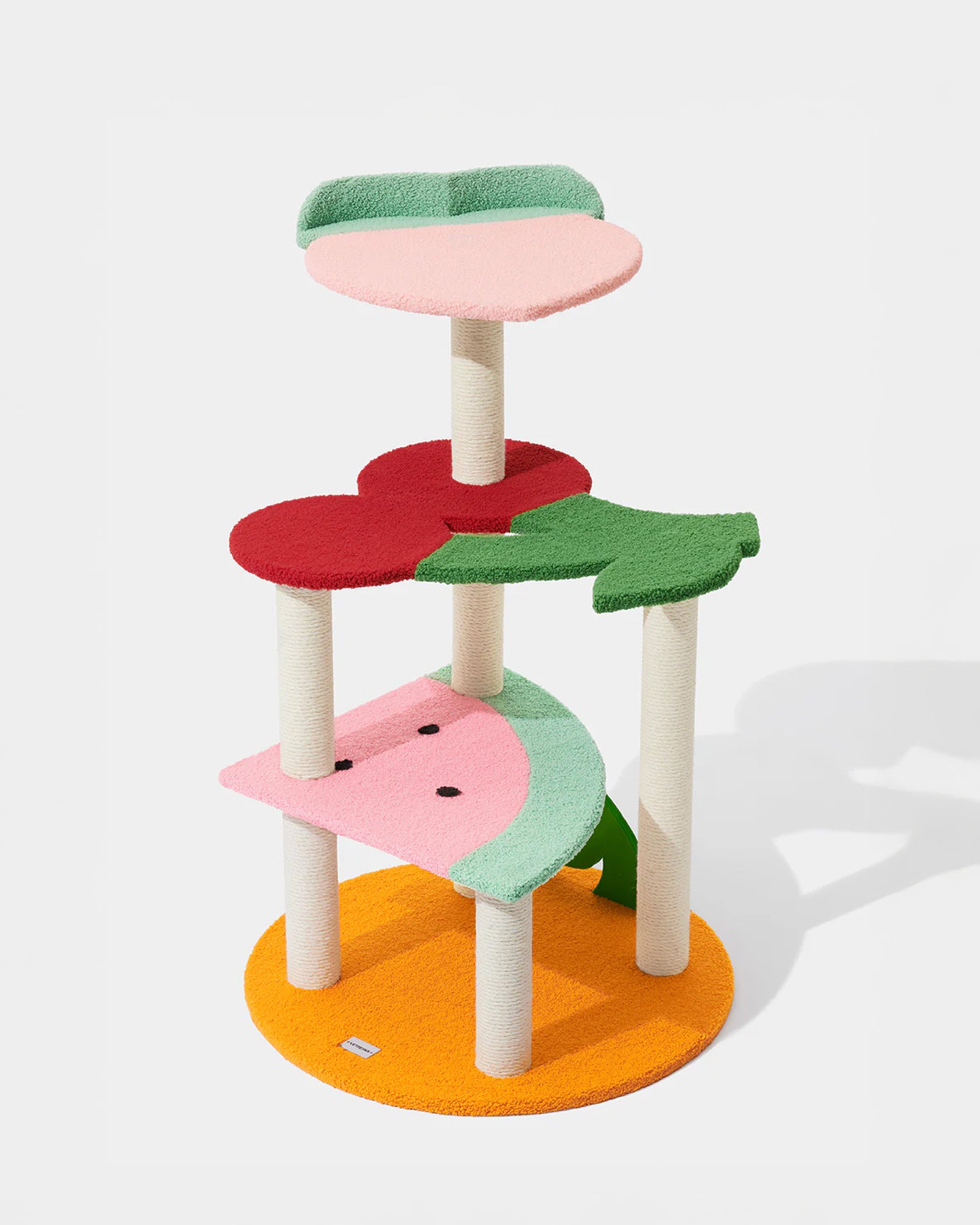 Colorful cat tree with multiple platforms on a white background