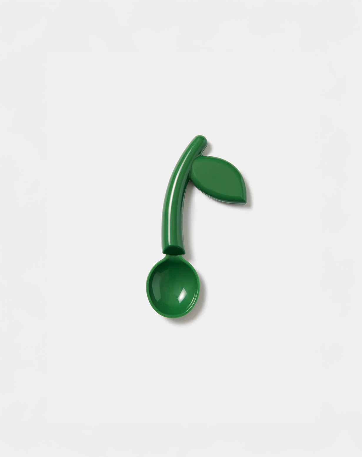 Green spoon with leaf design on a white background