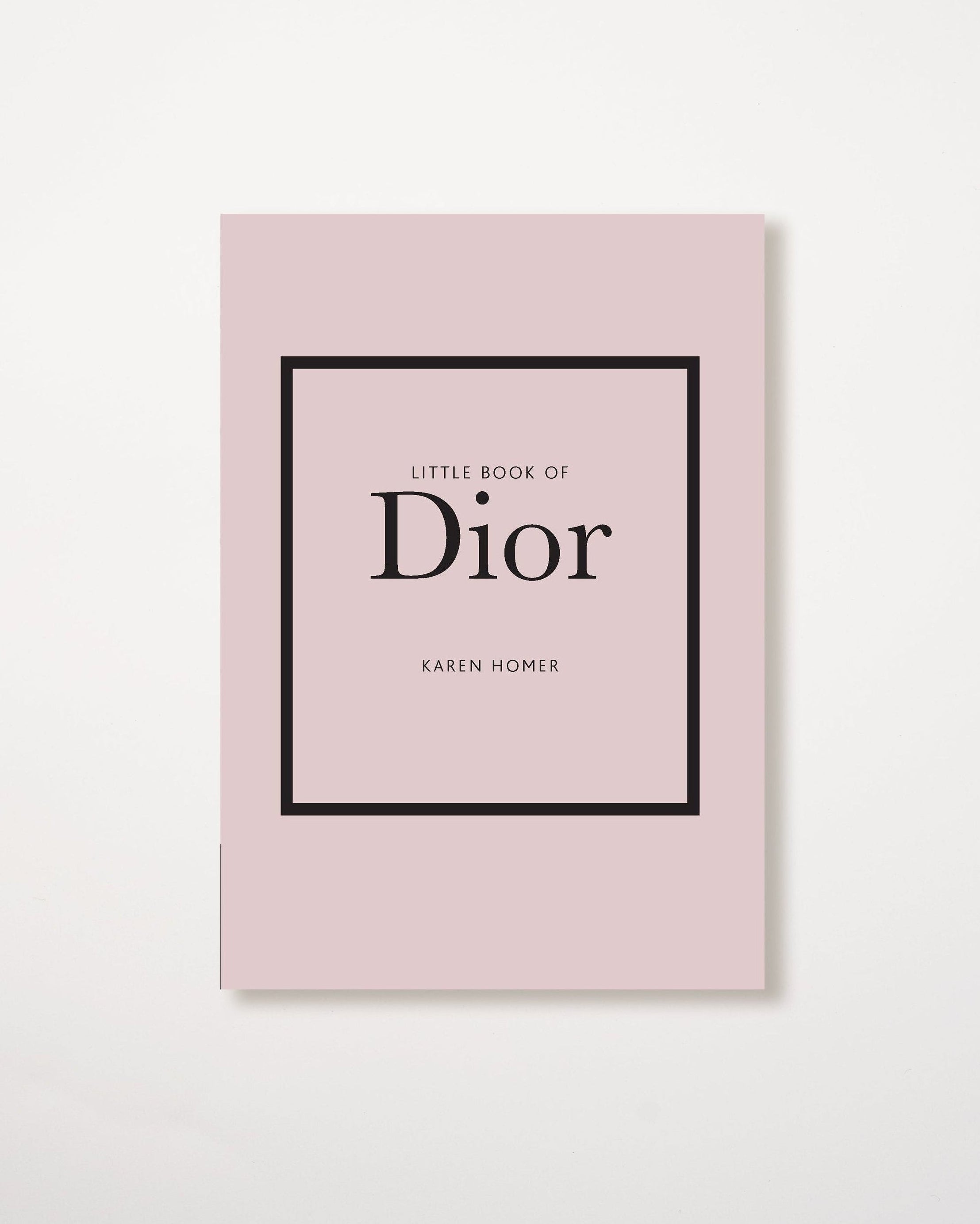 A pink book with the title 'Little Book of Dior' by Karen Homer in a black frame on the cover.