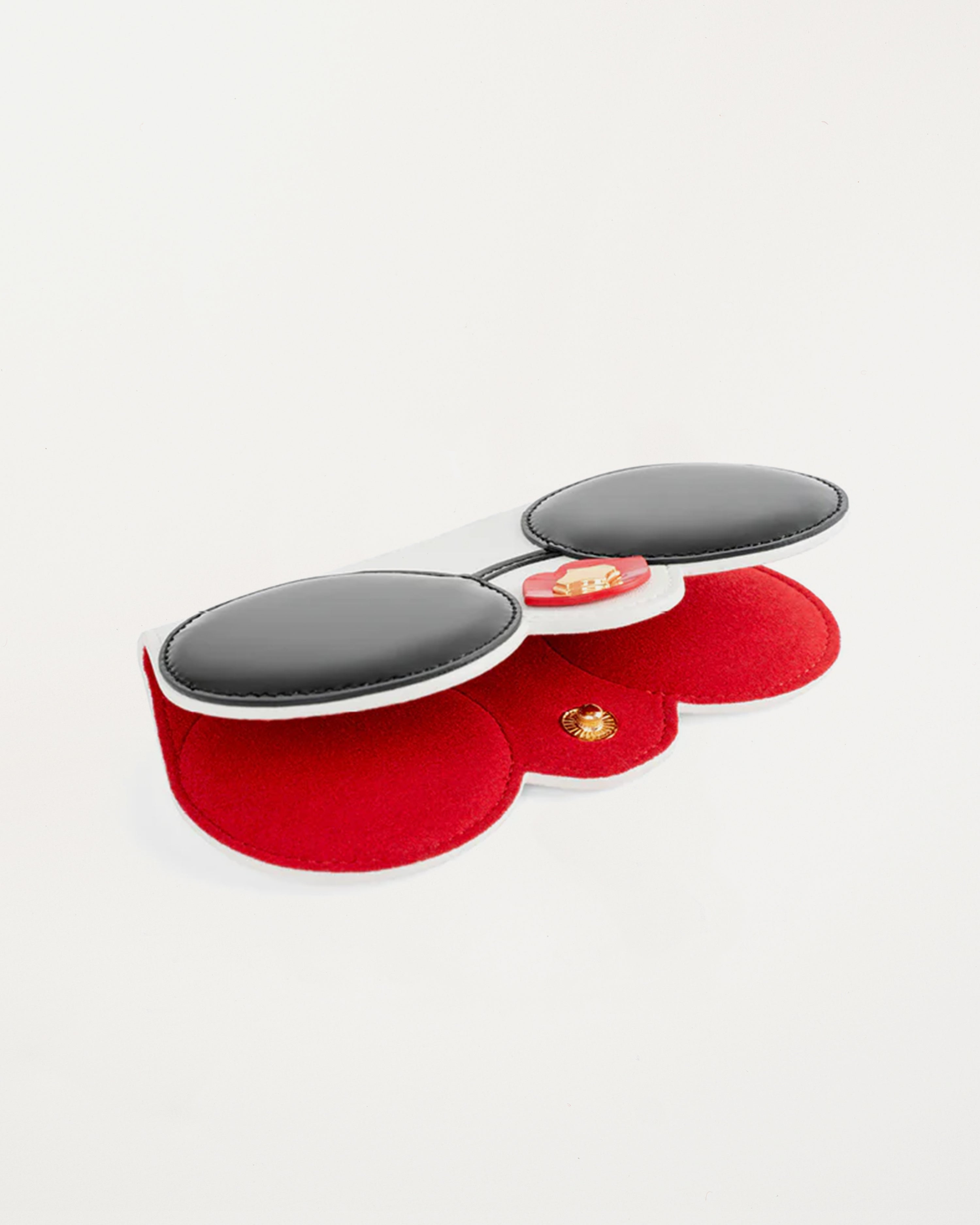 “Diva SunCover sunglasses case in white vegan leather with black round sunglasses face design and glossy red lips, inspired by CEO and designer Anne Dickhardt, gold-plated hardware”
