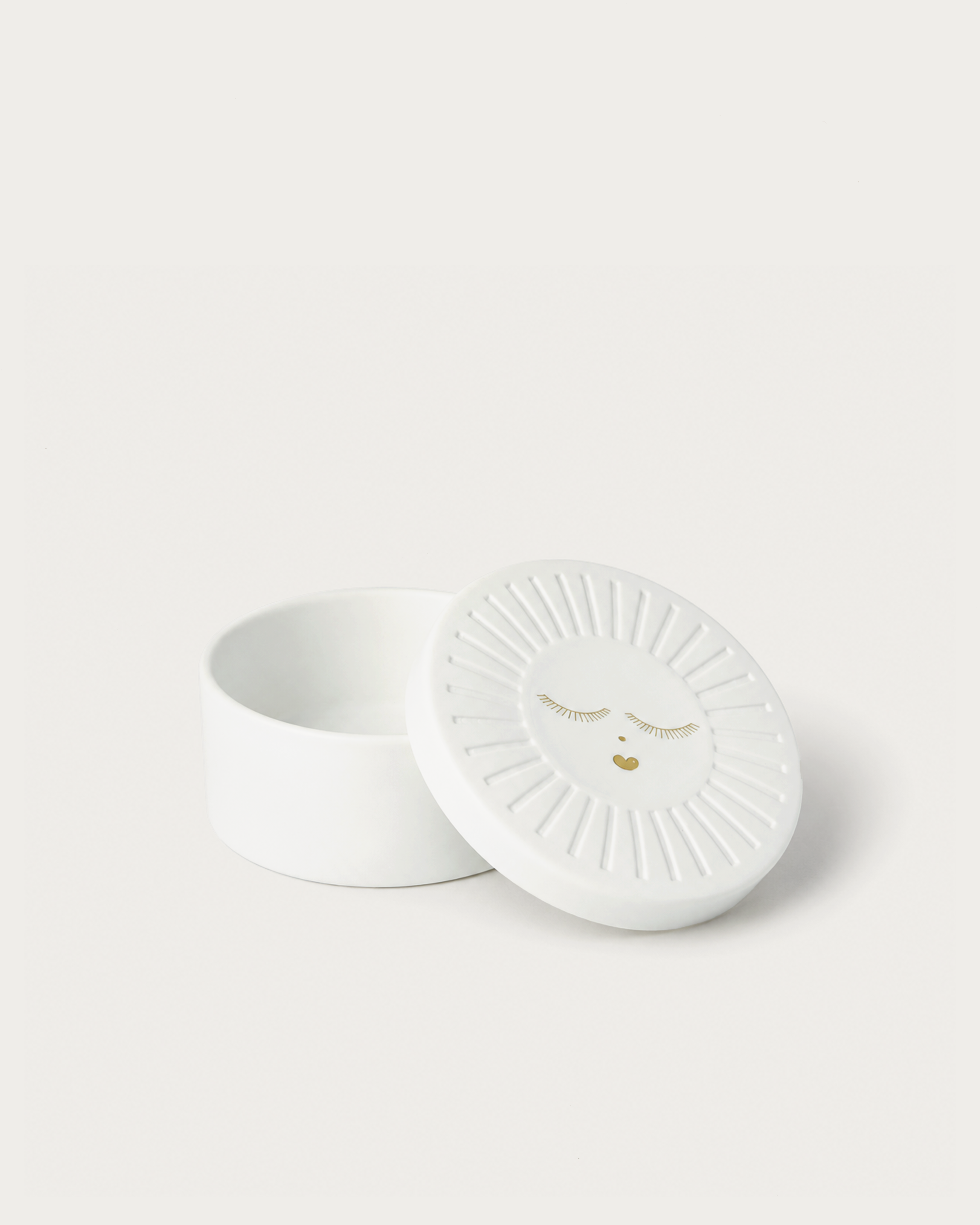 White ceramic dish with decorative design on a light gray background