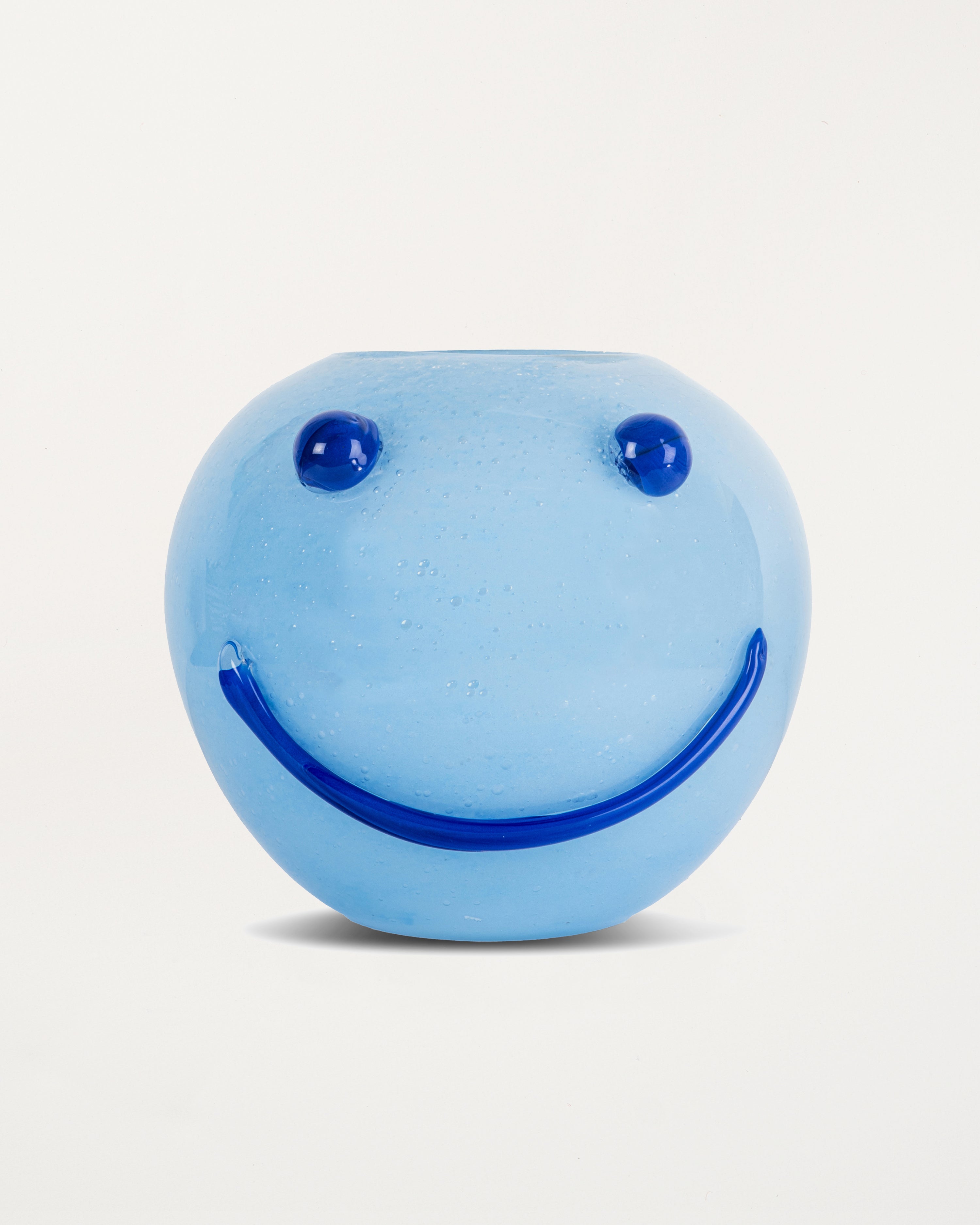Blue smiley face vase on a white background