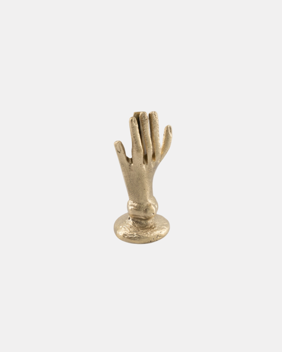 A gold-colored metal card holder in the shape of a hand.