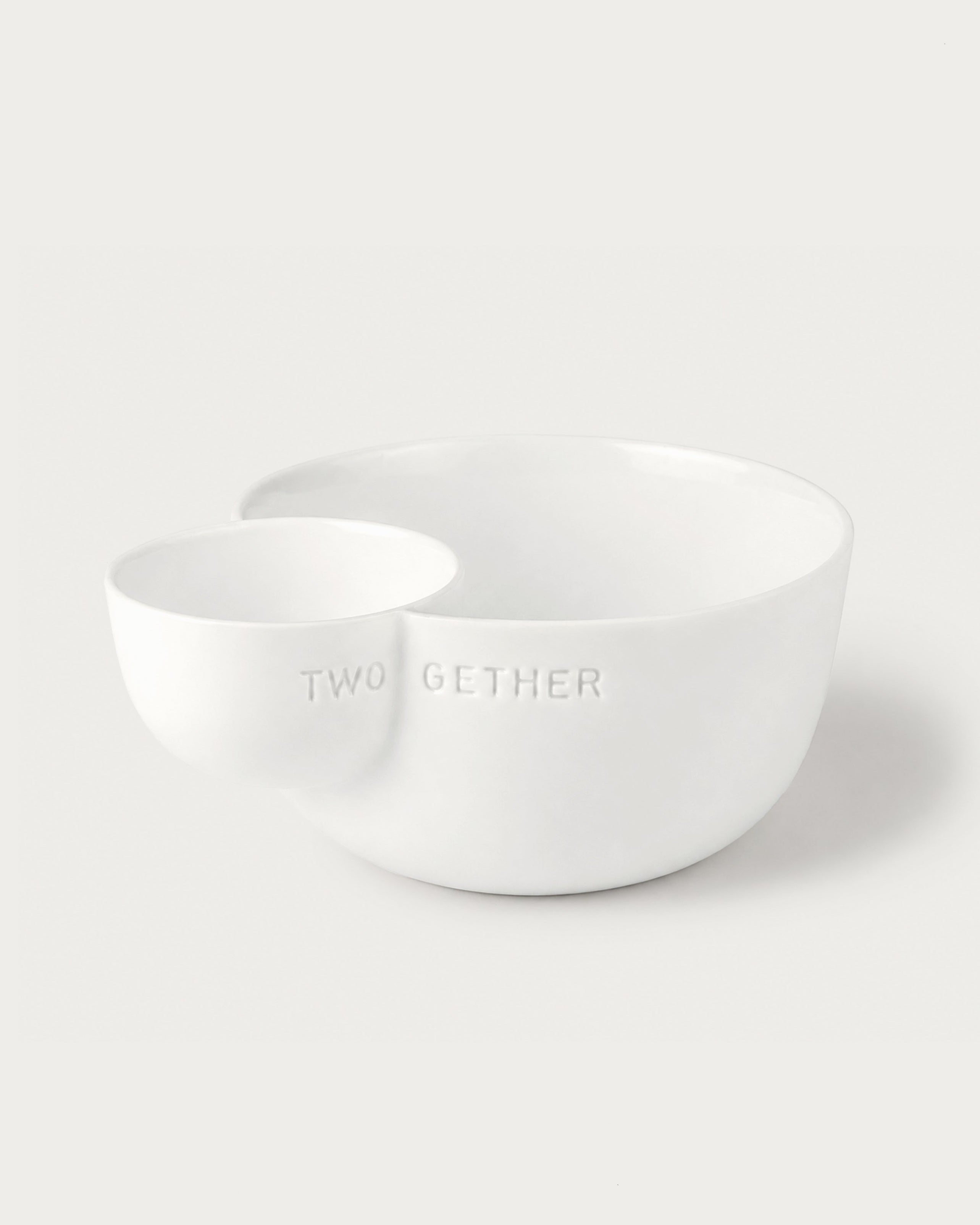 Two white ceramic bowls on a light gray background with 'TWOGETHER' text.
