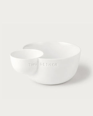 Two white ceramic bowls on a light gray background with 'TWOGETHER' text.