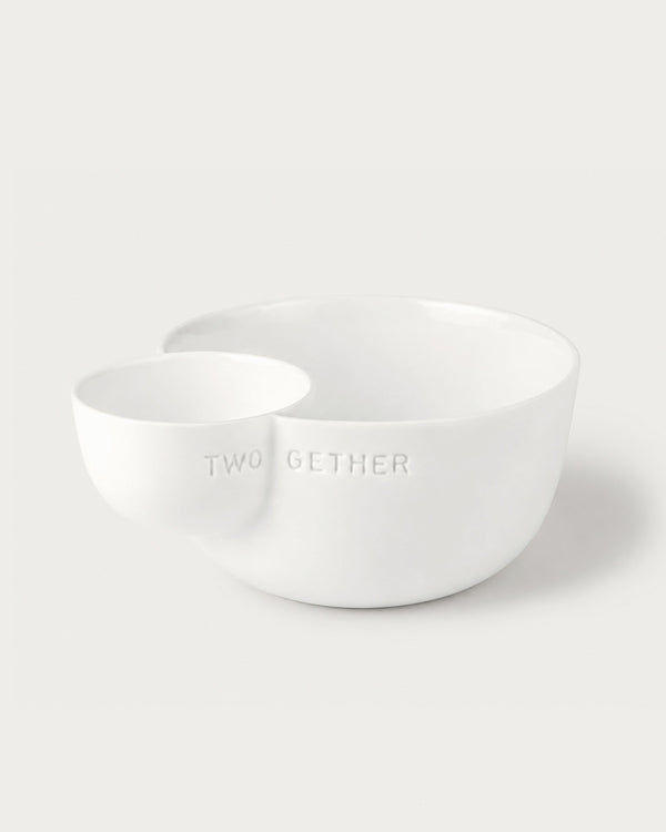 Two white ceramic bowls on a light gray background with 'TWOGETHER' text.