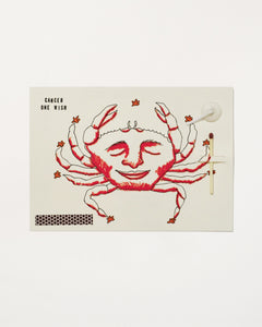 Cancer Zodiac Wish Card with illustration of a smiling crab and text on a white background, containing a match, strike pad and candlewick