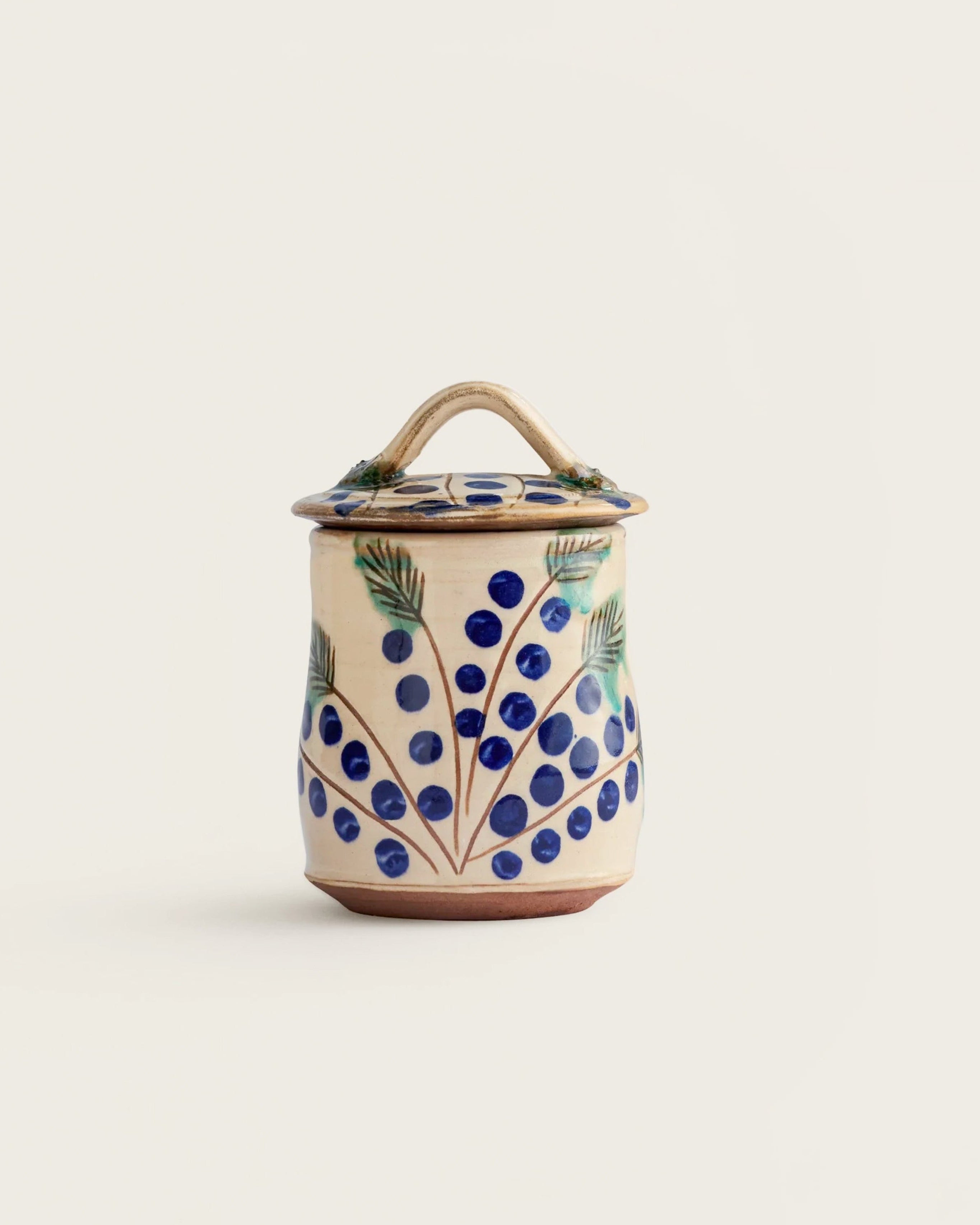 Ceramic jar with floral design on a white background