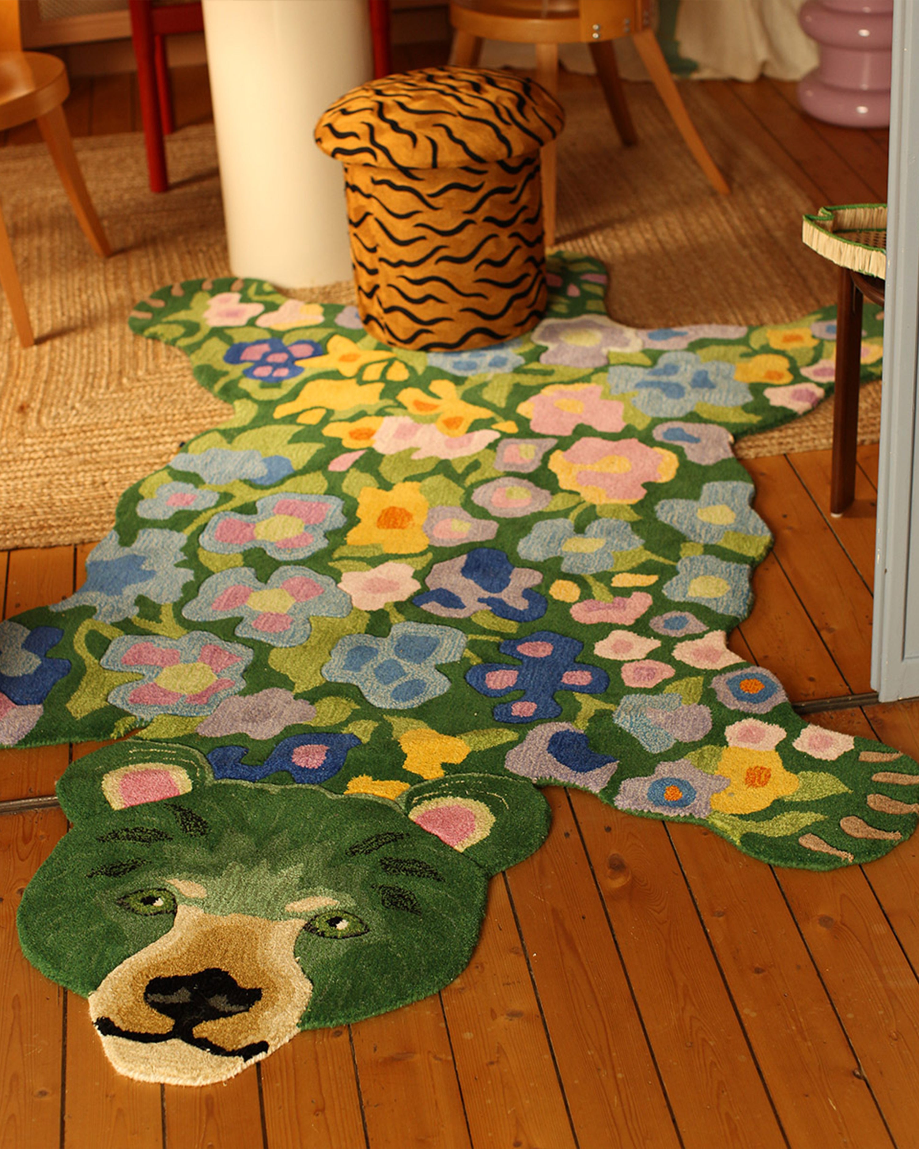 Floral green rug with flowers pattern on a wooden floor