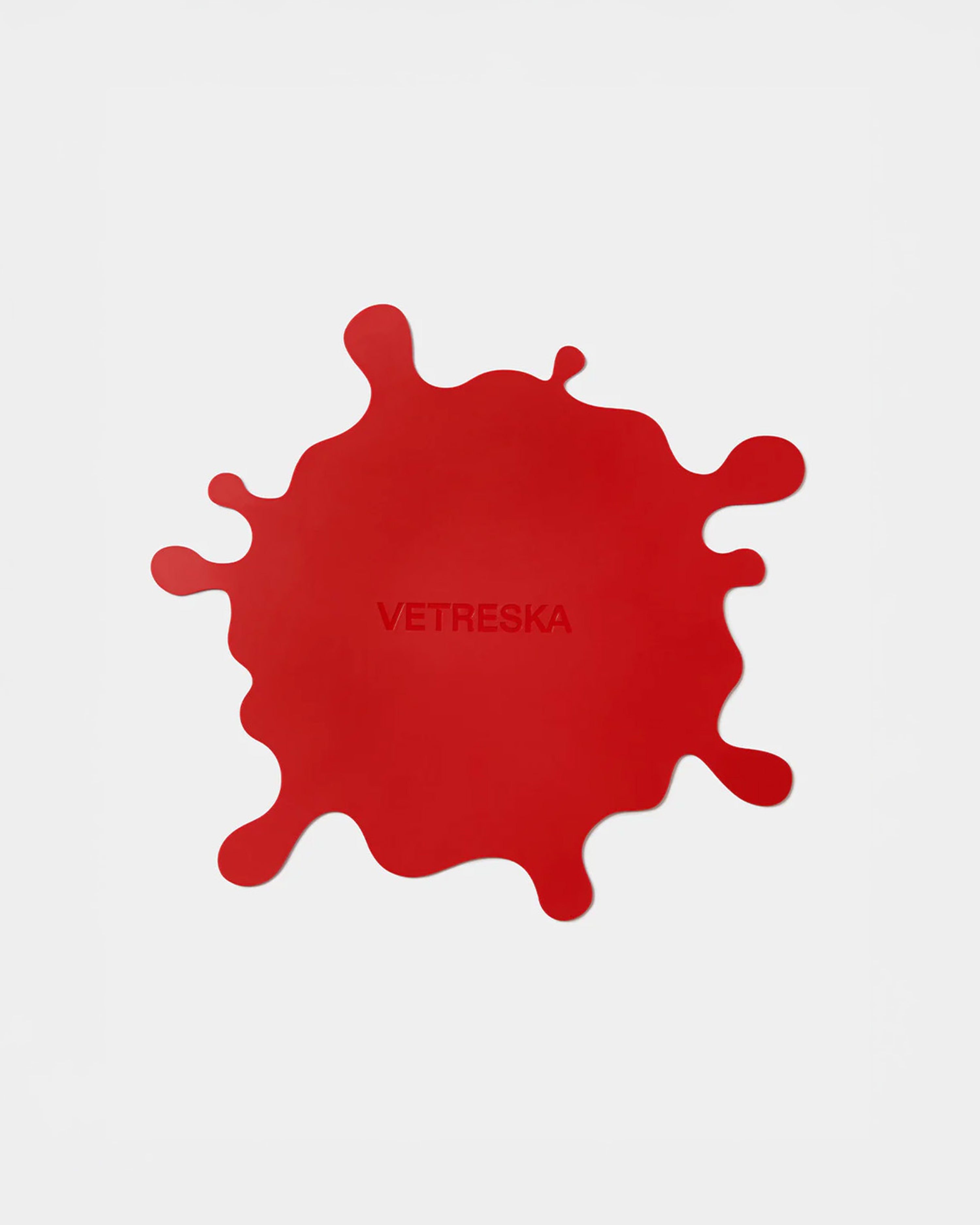 Red splatter mat design with 'VETRESKA' branding on a white background