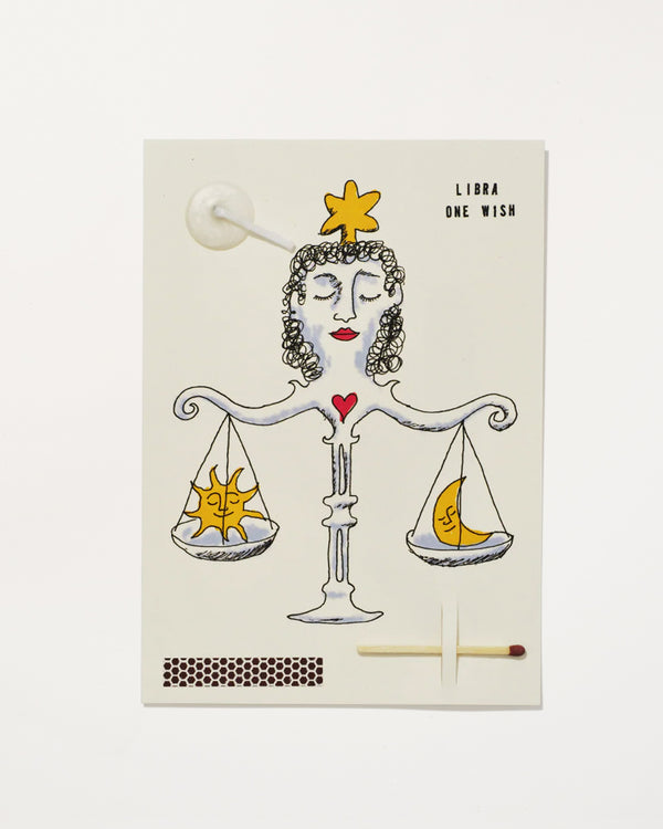 Libra Zodiac Wish Card with a hand illustrated woman forming balance scales that weigh a sun and a moon, with match, strike pad and candlewick.