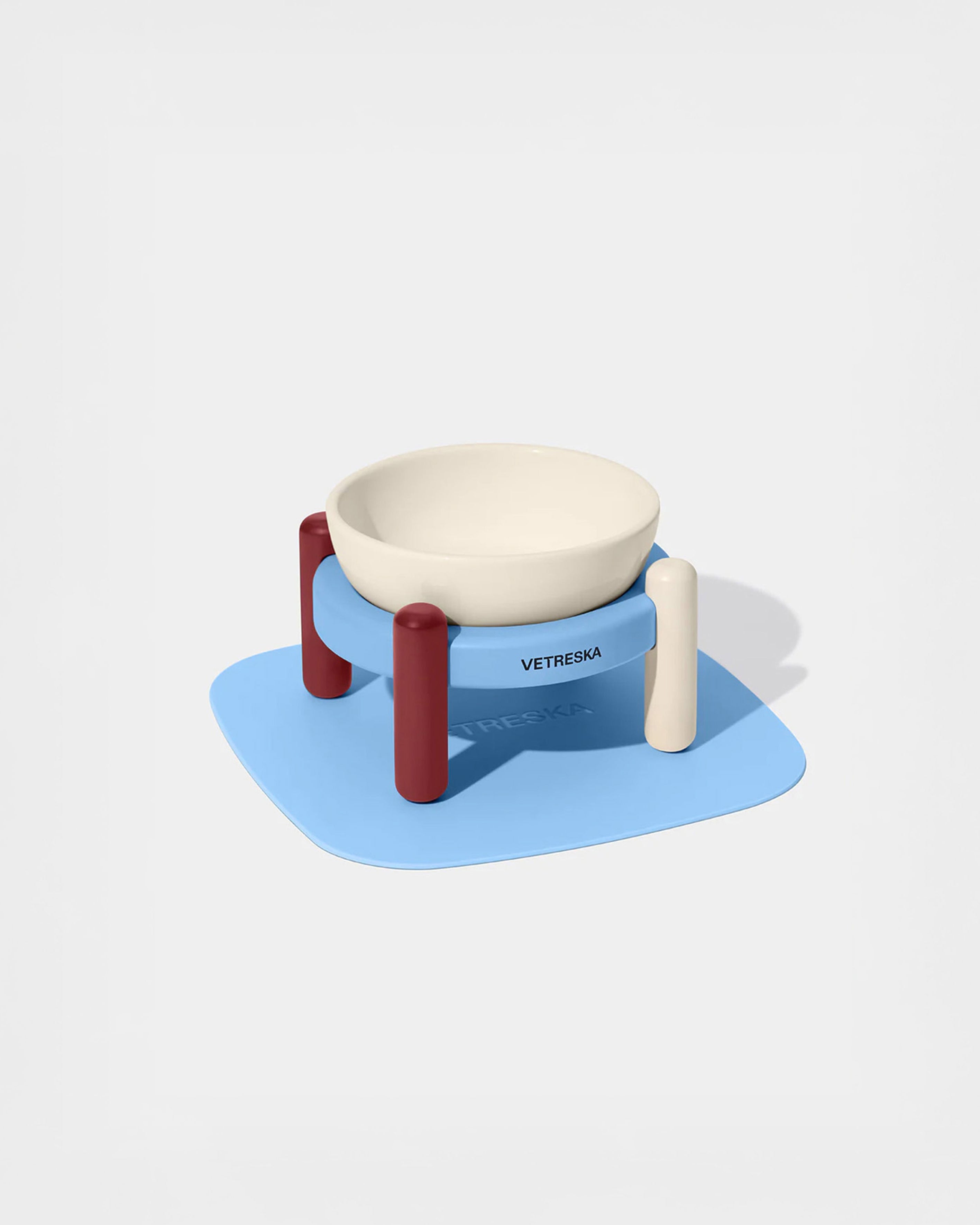 Pet bowl stand with a bowl and mat on a white background