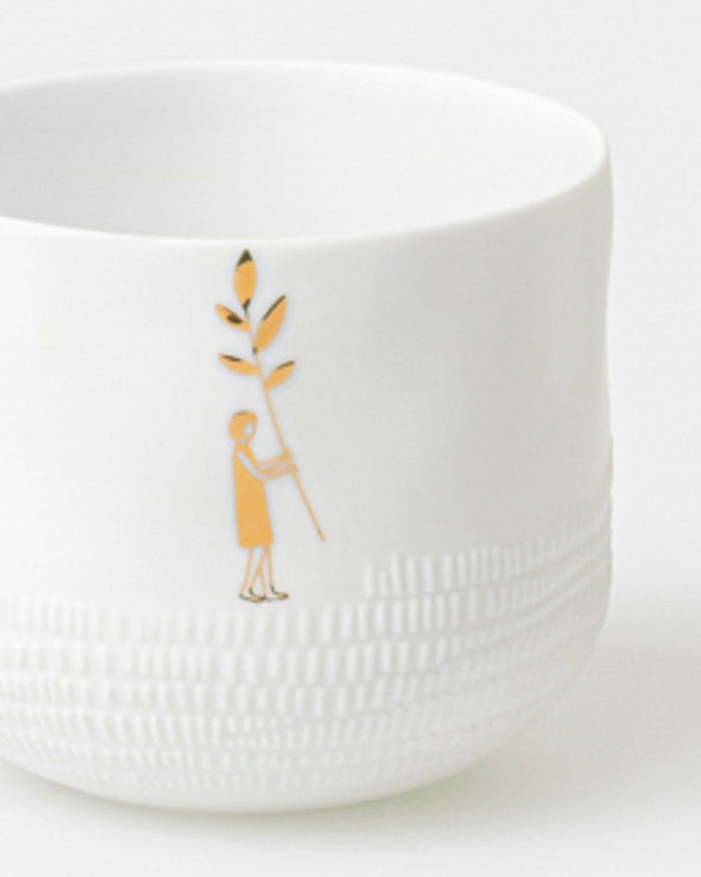 White textured bowl with a gold design on a white background