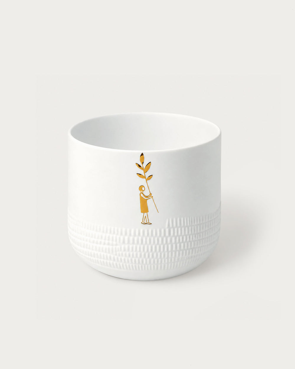 White textured bowl with a gold design on a white background