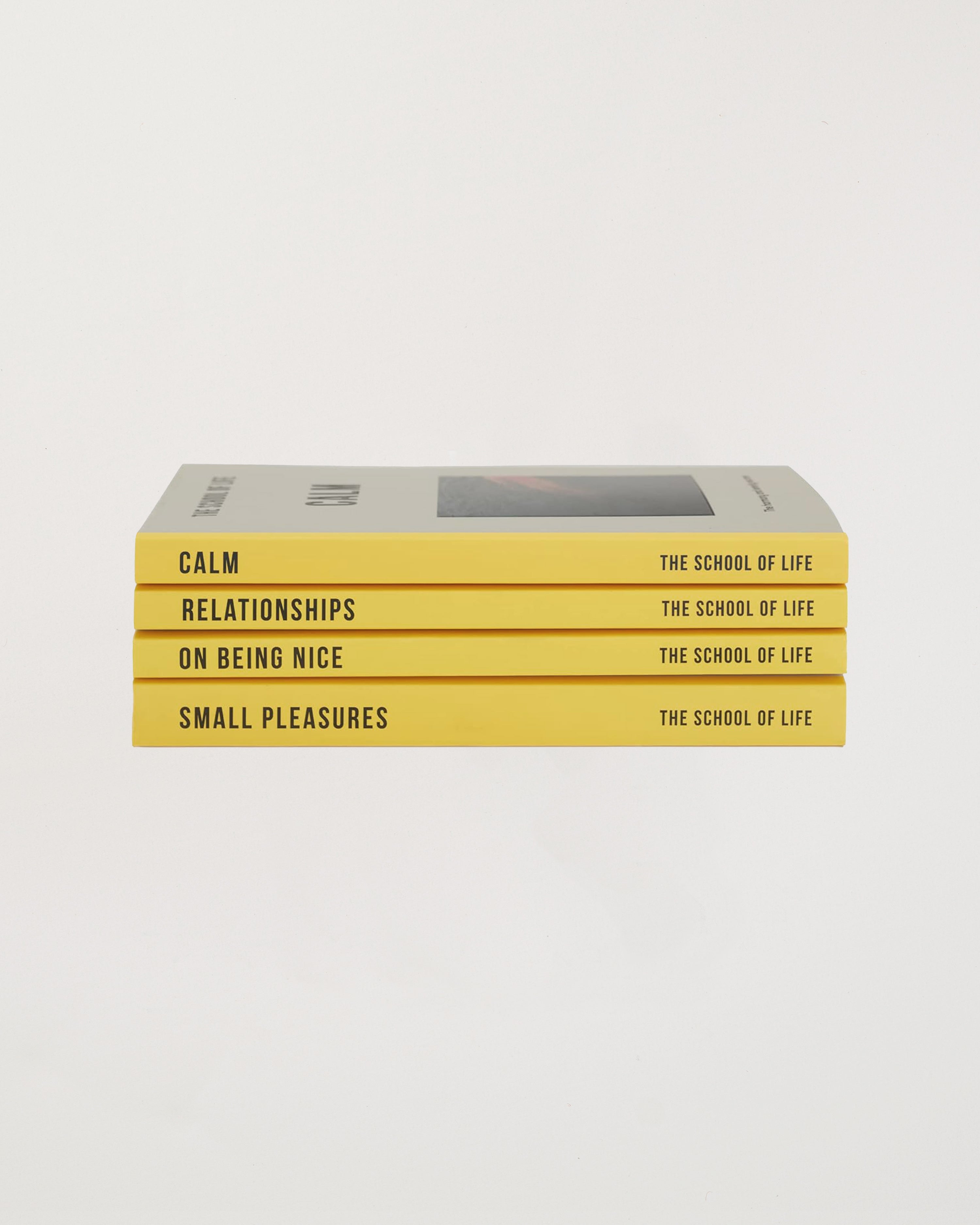 Stack of books titled 'Calm', 'Relationships', 'On Being Nice', and 'Small Pleasures' by The School of Life on a white background.