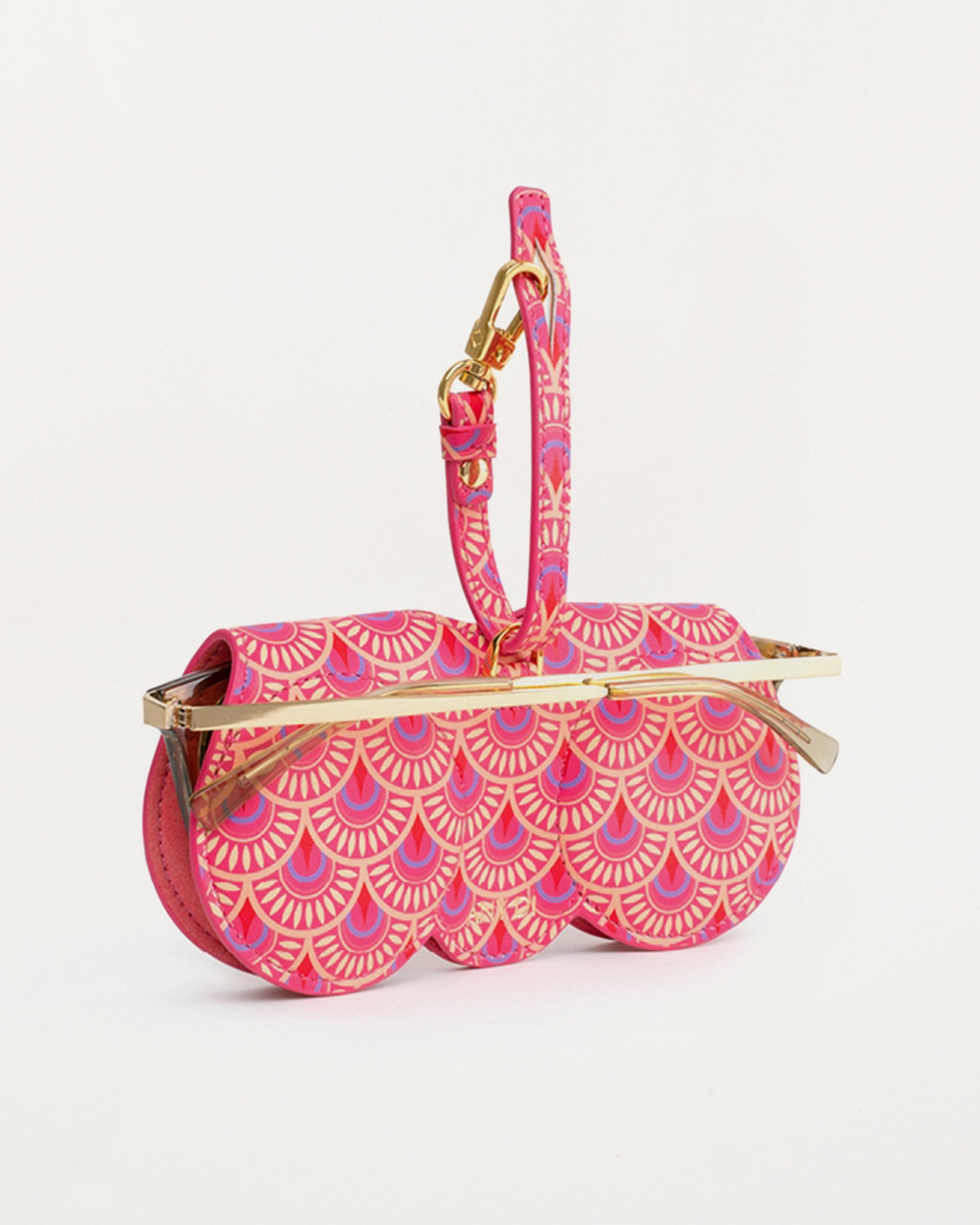 Aurora SunCover sunglasses case with floral silk-print pattern in red, orange and pink, round-edge shape and gold-plated hardware
