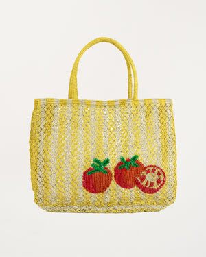 Yellow woven bag with tomato designs on a white background
