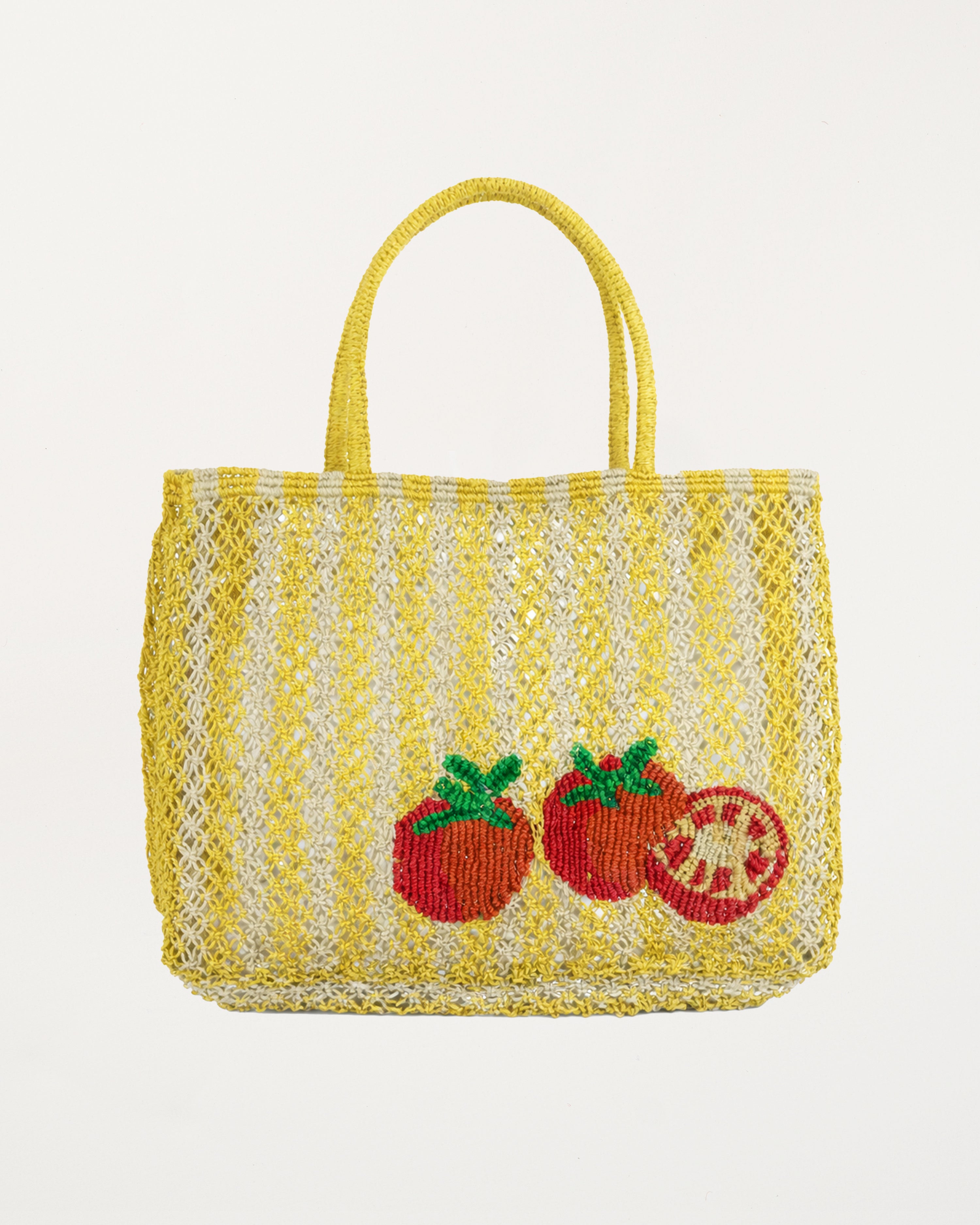 Yellow woven bag with tomato designs on a white background